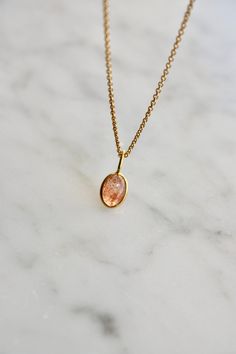 This tiny natural sunstone necklace is the perfect daily necklace for sunstone lovers. The necklace is 14k gold filled with a beautiful natural sunstone pendant in orange with copper schiller. The sunstone is set in 18 k gold. The pendant is 7x5mm. Layer it with your favorite necklaces, or wear it alone - it's perfect either way! About sunstone: The Stone of Good Fortune A warm stone with summer moods, first discovered here in Norway. It is said that the Vikings used this shimmering bright stone Orange Gemstone Necklace, Sunstone Necklace, Daily Necklace, Sunstone Jewelry, Jewelry Dainty, Native American Culture, Etsy Personalized Gifts, Necklace Personalized, Gold Filled Chain