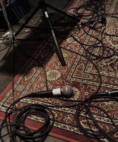 there is a microphone on the floor with wires all over it