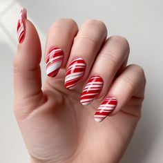 Get into the holiday spirit with these festive candy cane nails. Perfect for adding a playful touch to your look. #CandyCaneNails #NailInspiration Candy Cane Nail Ideas, Candy Cane Nails Almond, Candy Cane Stripe Nails, Candycane Nailart, Candy Cane Nails Acrylic, Candy Cane Nail Designs, Candy Cane Christmas Nails, Candy Cane Nail Art, Nails Candy Cane