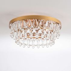 a chandelier hanging from the ceiling with glass drops on it's sides