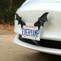 a white car with black bats on it's license plate that says california everymp