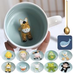 a person holding a coffee cup with various animal figurines in it and gold spoon