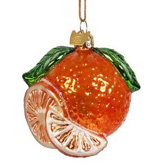 an orange ornament hanging on a chain with a piece of fruit cut in half