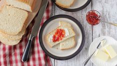 slices of bread on plates with jam and butter