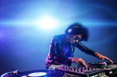 a man that is playing some kind of music on a turntable with headphones