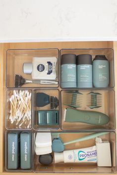 an organized drawer with toothbrushes and other items