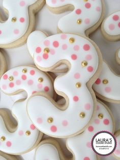 decorated cookies with pink and white polka dots are arranged in the shape of an s