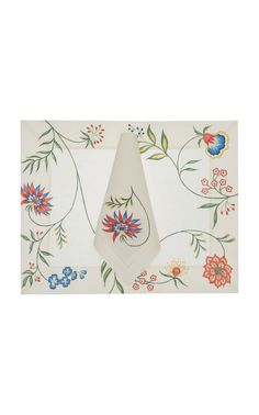 a white table cloth with colorful flowers and leaves on the border, in front of a white background