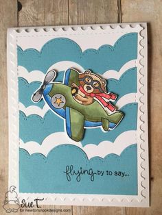 a handmade card with an airplane and a bear in the sky on it's side