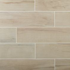 a white tile wall that has been made with wood grains and is being used as a floor covering