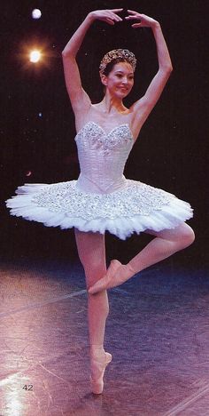 a young ballerina in white tutu and tiara