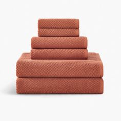 five orange towels stacked on top of each other