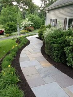 a stone walkway in front of a house