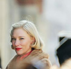 a woman with blonde hair is walking down the street