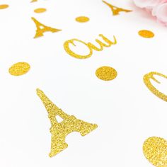 gold glitter confetti on white paper with pink flowers