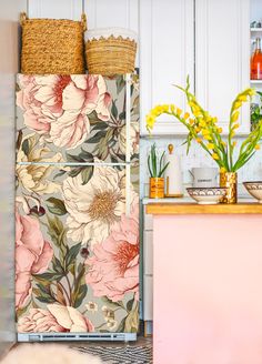 a refrigerator covered in flowers next to a counter