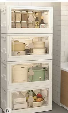 three shelves filled with dishes and containers in a kitchen next to a white counter top