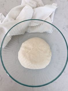 a ball of dough in a glass bowl