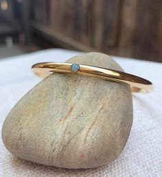 The Gemmed Half Round cuff bangle custom jewelry gem bracelet opal turquoise gemstone birthstone bra Everyday Brass Jewelry With Birthstone, Gold Gemstone Bangle As A Gift, Adjustable Opal Birthstone Jewelry, Stackable Brass Jewelry As Gift, Stackable Brass Jewelry Gift, Gold Opal Stackable Jewelry, Gold Stackable Jewelry With May Birthstone, Minimalist Oval Bangle As A Gift, Gold Stackable Jewelry For May Birthstone