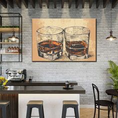 two glasses of whiskey sitting on top of a counter next to bar stools in front of a brick wall