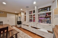 a living room filled with lots of white furniture