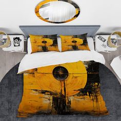 a bed with yellow and black art on the comforter, pillows and pillow cases