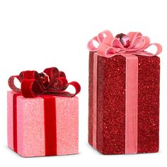 two red gift boxes with bows and ribbons on them, one has a pink ribbon