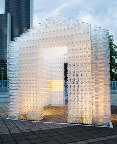 an outdoor structure made out of plastic bottles