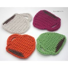 four crocheted items are arranged in the shape of purses, one with an eye patch