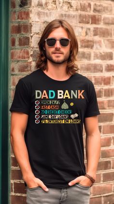 a man with long hair and sunglasses standing in front of a brick wall wearing a t - shirt that says dad bank