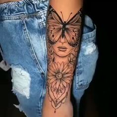 a woman's arm with a butterfly and flowers tattoo on the left side of her leg