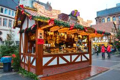 an outdoor food stand with lights and decorations