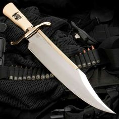 a gold colored knife on top of a black bag