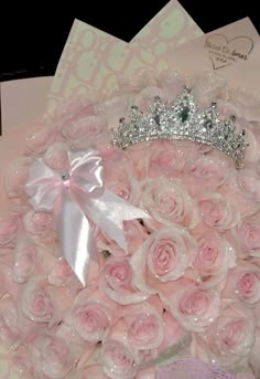 a bouquet of pink roses with a tiara on top