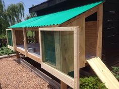 a small chicken coop with a green roof