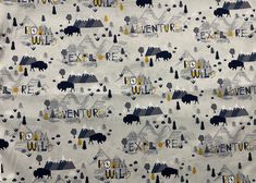 an animal themed fabric with the words adventure written in large letters and trees on it