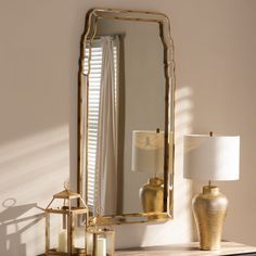 a mirror sitting on top of a dresser next to a lamp