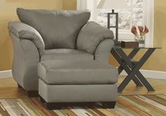 a gray chair and ottoman in a room