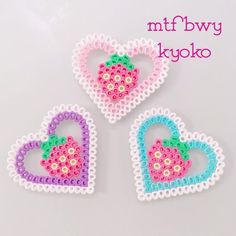 three heart shaped beaded brooches on a white background with the words mttbwy kyoku written below them