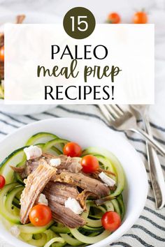 a white bowl filled with meat and veggies on top of a striped table cloth