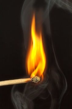 a burning matchstick with yellow and red flames