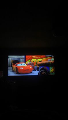 an image of cars on a screen in the dark