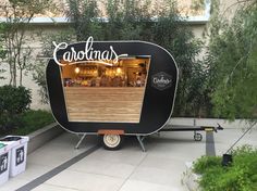 a black and white trailer parked in front of a building