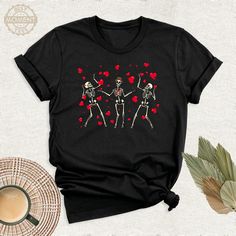 Valentines Day Dancing Skeletons Shirt, Sarcastic Gift Little Red Hearts Tshirt, Valentine Funny Outfit, Funny Skeleton Birthday Gift Shirt. Welcome to BestMomentTees! Step into a world of comfort and style with our handmade shirts from the renowned Bella Canvas brand. The solid colors are 100% pure cotton, while the delightful heather colors are a charming blend of 52% cotton and 48% polyester. 🍃 Each shirt is a true labor of love, meticulously created using the innovative DTF printing method. Red Graphic Print Top As Gift, Funny Valentine's Day Tops With Letter Print, Funny Letter Print Tops For Valentine's Day, Fun Red T-shirt, Black Graphic Print Top For Valentine's Day, Black Casual Shirt For Valentine's Day, Casual Black Shirt For Valentine's Day, Funny Graphic Print T-shirt For Valentine's Day, Halloween Graphic Print Top As Gift