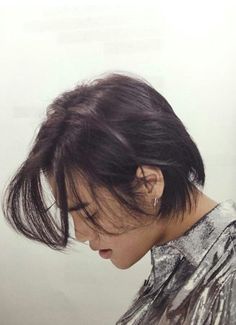 a woman with her hair in a messy ponytail