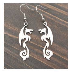 Dainty dangle silver colour stainless steel dragon earrings, Cool dragon lover jewelry for him or her Carefully handcrafted from silver plated hooks, lever back hoops or clip-ons and stainless steel dragons, they are lightweight, built to last and you can wear them comfortably all day long.  Additionally, these earrings come in a gift box, making them the perfect thoughtful gift for the dragon warrior in your life. Gold ones available here: bysantana.etsy.com/listing/1589771743 All packages are sent by priority mail with a tracking number for your convenience and peace of mind. x Handmade in Germany x My other items can be found here: bysantana.etsy.com Favorite my shop to receive updates on new items! Steel Dragon, Lover Jewelry, Dragon Warrior, Cool Dragons, Dragon Earrings, Quirky Earrings, Dragon Lover, Fantasy Lovers, Mythical Creature