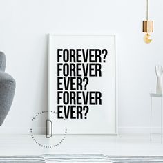 a black and white poster with the words forever on it next to a gray chair