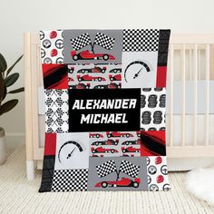 a baby crib with a car themed blanket