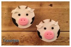 two cupcakes that have been decorated to look like cows