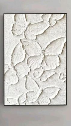 an abstract painting with white paint on the wall